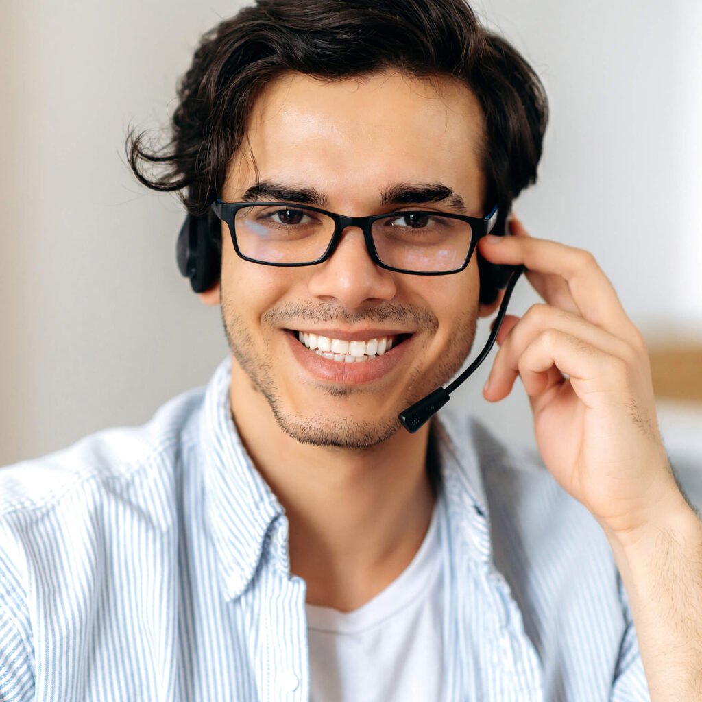 Smiling support professional wearing a headset, representing TinyEYE's free consultation for online therapy services.